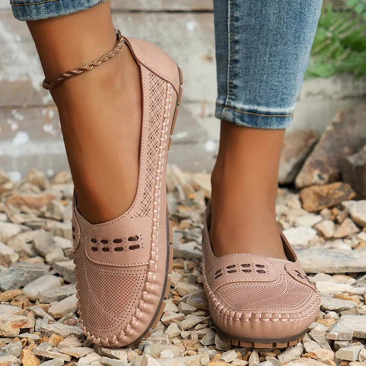 Close-up of women's perforated slip-on loafers showcasing textured orthopedic comfort.