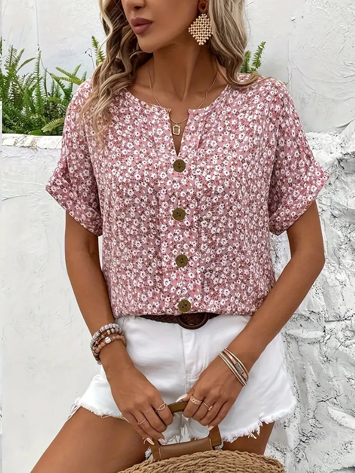Pink floral relaxed fit button-up blouse for women. Elegant long sleeve top, great for versatile spring fashion.