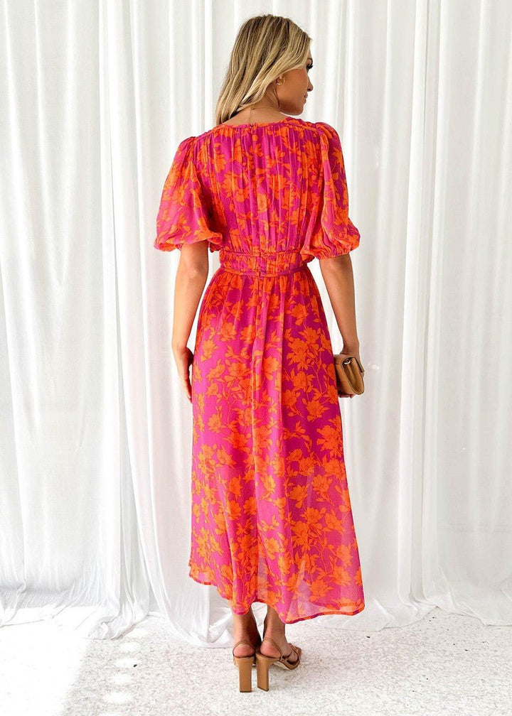 Vibrant pink-orange floral print maxi dress for women, featuring a V-neck and stylish puff sleeves. Casual & comfy.
