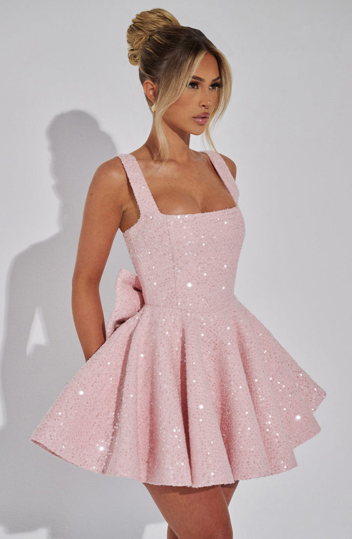 Women's pink sequin skater dress with a bow, short style for homecoming, parties, or special occasions.