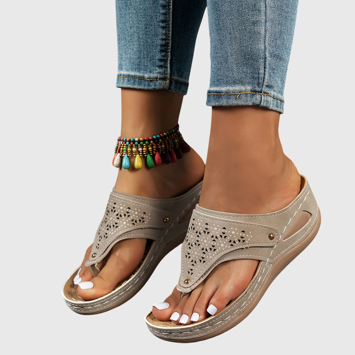 Stylish women's platform sandals with ankle strap and perforated design. Perfect summer fashion footwear.