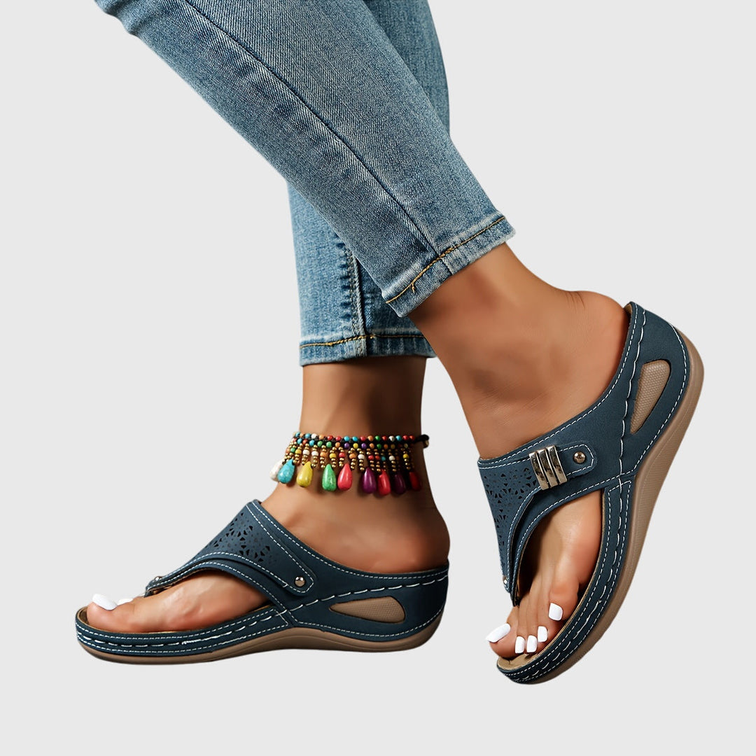 Elegant women's platform sandals featuring an ankle strap and chic perforated design. Summer essential.