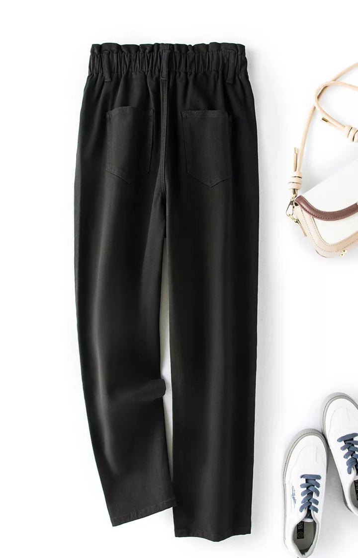 Detail of the high-waist and pockets on women's plus size stretch mom jeans.