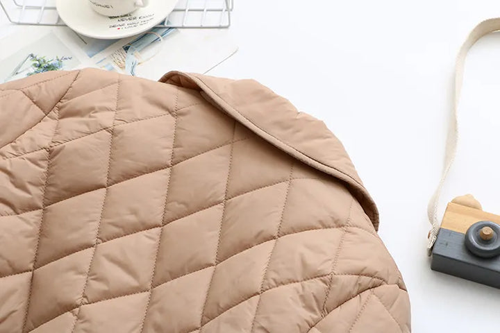 Women's plus size quilted jacket with elegant fall leaf print. Winter fashion statement.