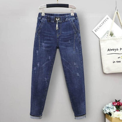 Stylish plus size high-waisted baggy jeans with stretch denim, offering a chic street style look for women.