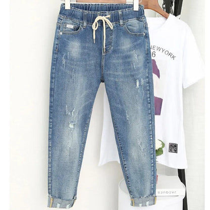 Plus size women's stretch baggy jeans in a dark wash, high-waisted for a comfortable, fashionable relaxed fit.