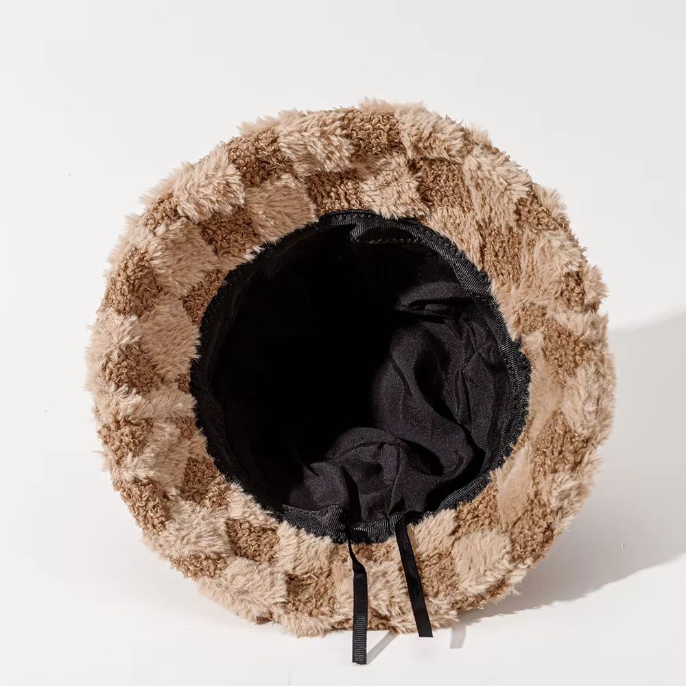 Fuzzy plush checkerboard bucket hat for women. This warm winter accessory offers cozy style and comfort.