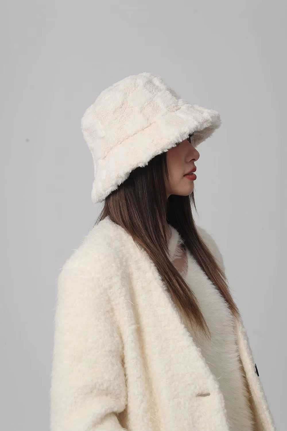 Trendy checkerboard pattern on a plush women's bucket hat. Perfect cozy and warm fall/winter accessory.