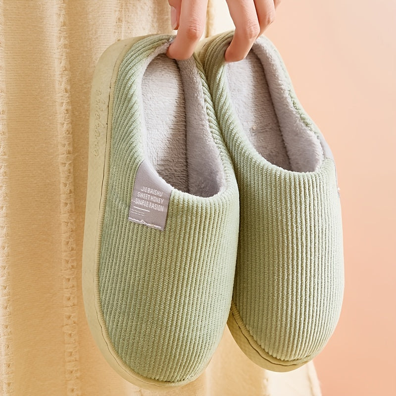 Cozy women's plush house slippers with non-slip soles, perfect for home comfort.