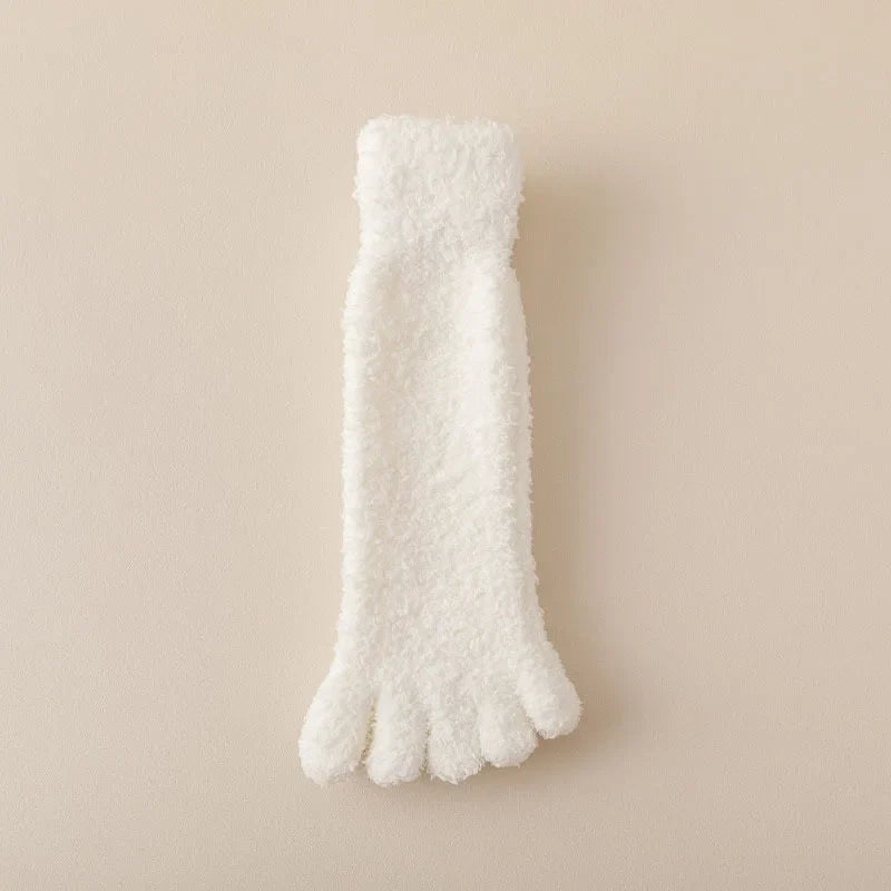 Close-up of women's plush cozy toe socks, highlighting soft texture. Warm winter loungewear for home comfort.