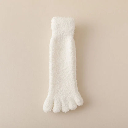 Close-up of women's plush cozy toe socks, highlighting soft texture. Warm winter loungewear for home comfort.