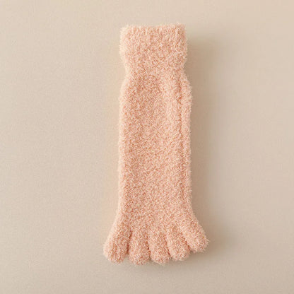 Woman wearing soft plush toe socks, enjoying cozy home comfort. Warm loungewear for ultimate relaxation.