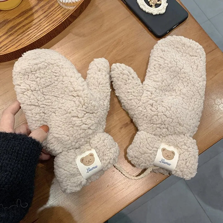 Fashionable women's plush mittens with a cozy teddy texture, essential cold weather gear.