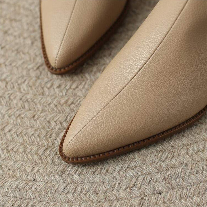 Modern women's pointed toe ankle boots, slip-on convenience, comfortable low heel. Everyday chic.