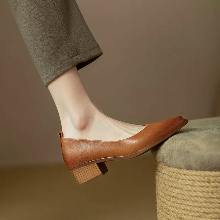Stylish women's pointed toe block heel slip-on court shoes, offering comfort and a professional look.