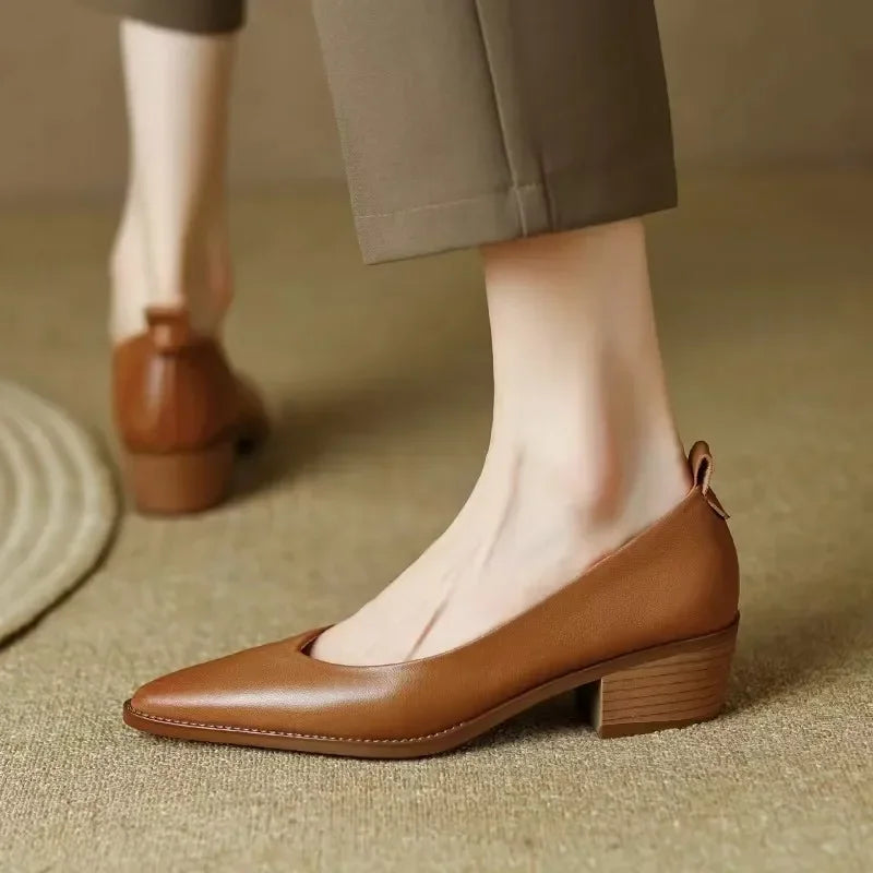 Classic women's court shoes, featuring a pointed toe, block heel, and convenient slip-on design.