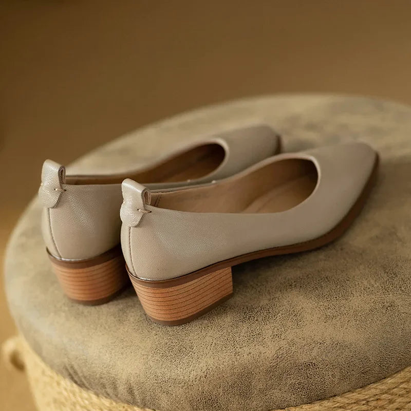 Neutral-colored women's pointed toe block heel slip-on court shoes, ideal for versatile styling.