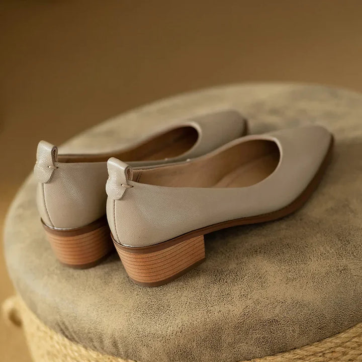 Neutral-colored women's pointed toe block heel slip-on court shoes, ideal for versatile styling.