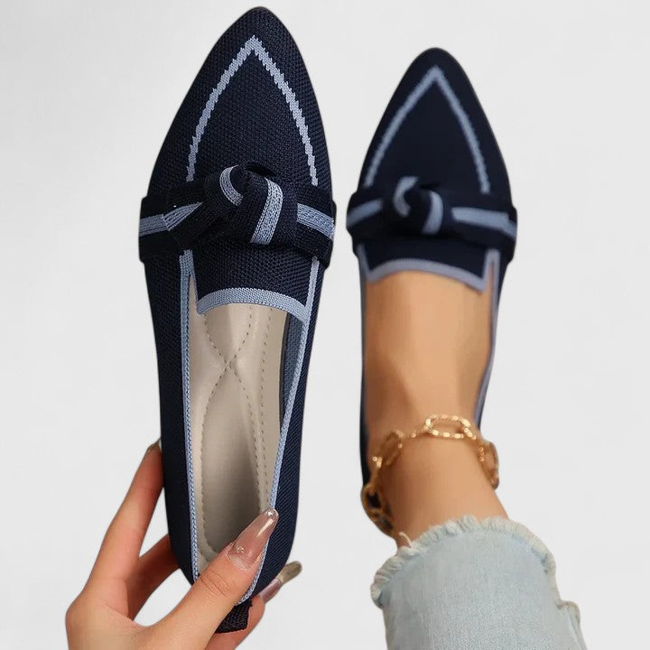 Woman wearing comfortable pointed toe slip-on loafers with a chic contrast trim, perfect for versatile daily style.