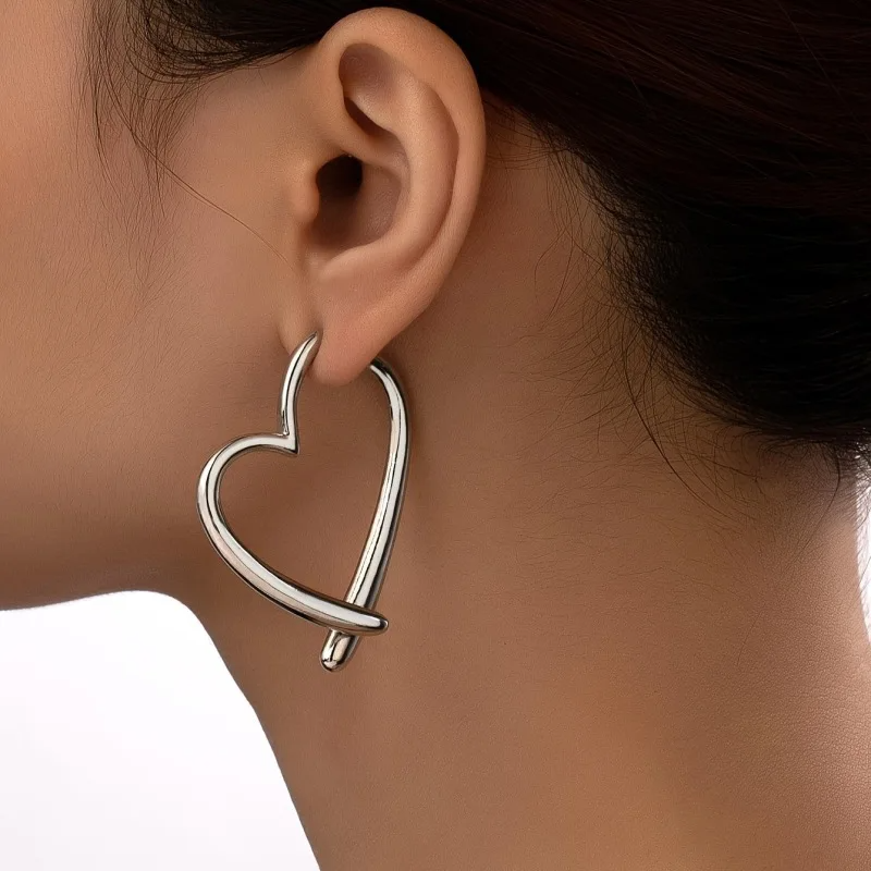 Silver-tone women's polished heart hoop earrings. Fashionable non-tarnish jewelry, ideal for elegant daily wear.