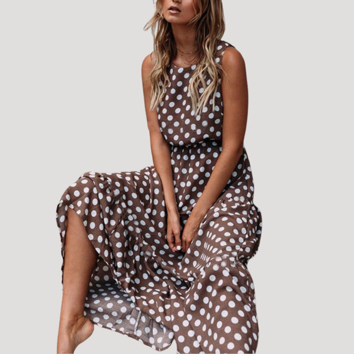 Women's polka dot sleeveless midi dress with a flowy A-line cut, perfect for summer casual wear.