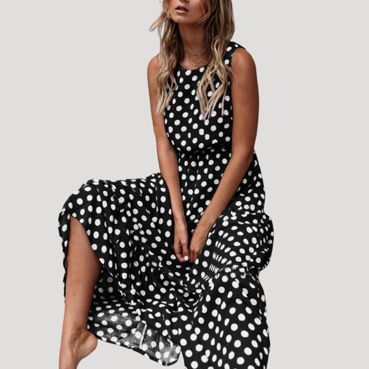 Stylish women's A-line polka dot midi dress, sleeveless and flowy, ideal for vacation or casual summer.