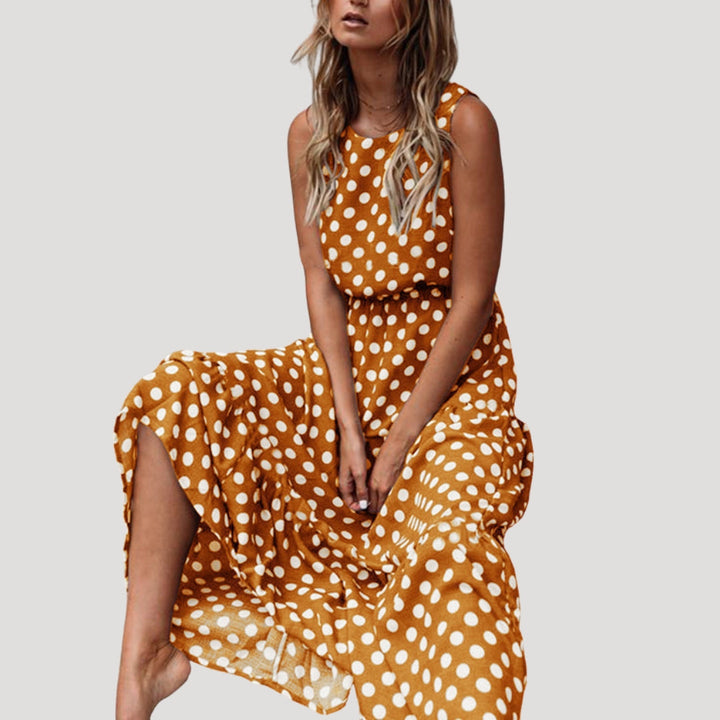 Comfortable women's sleeveless polka dot midi dress, A-line flowy design with a round neck for summer.