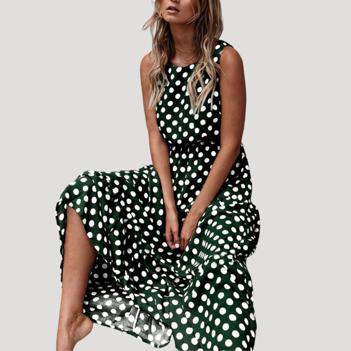 Model wearing a black & white polka dot sleeveless midi dress, flowy A-line style, perfect for a summer day.