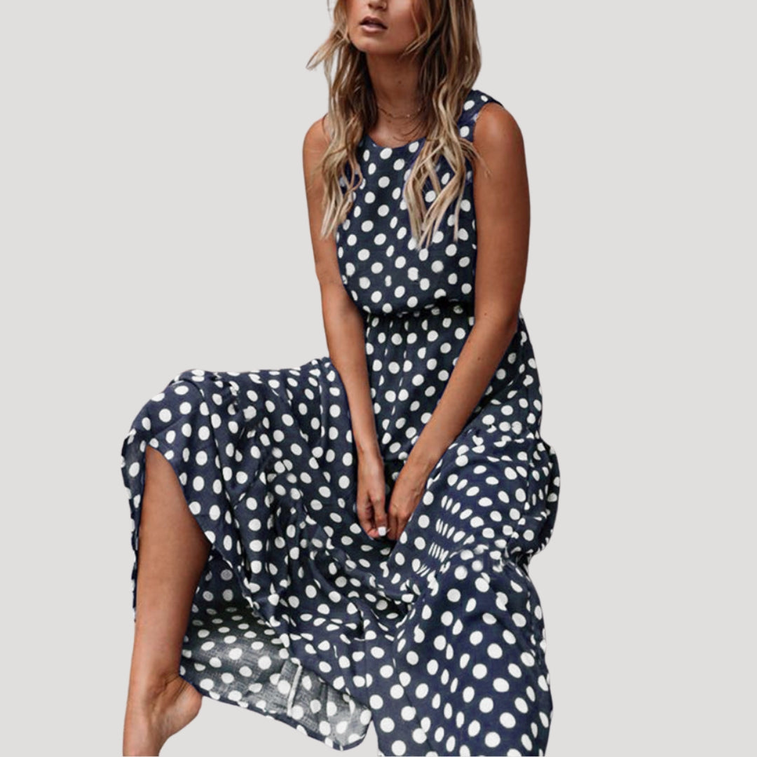 Women's casual sleeveless polka dot midi dress. Flowy A-line design, round neck, perfect for summer vacations.