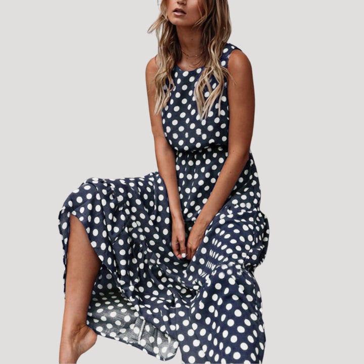 Women's casual sleeveless polka dot midi dress. Flowy A-line design, round neck, perfect for summer vacations.