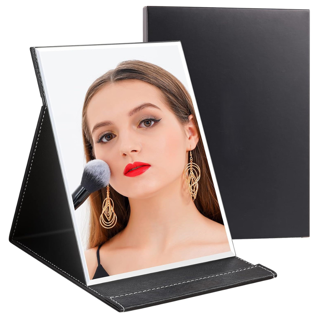 Women's portable compact make-up mirror with stand, ideal for travel & daily beauty touch-ups.