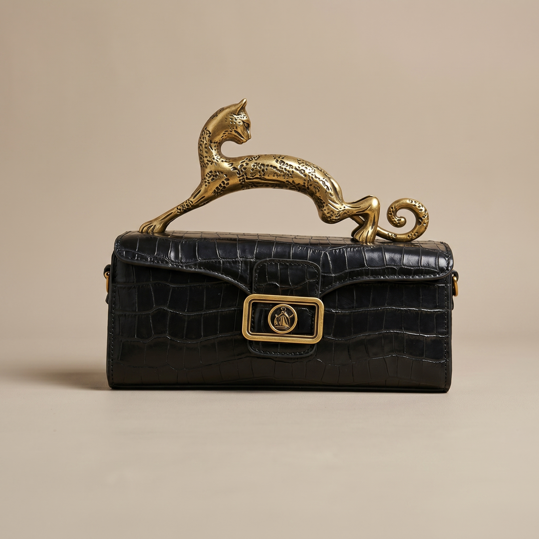 Sculptural Portia leather handbag for women, showcasing a rich leopard print texture & sophisticated brass accents.