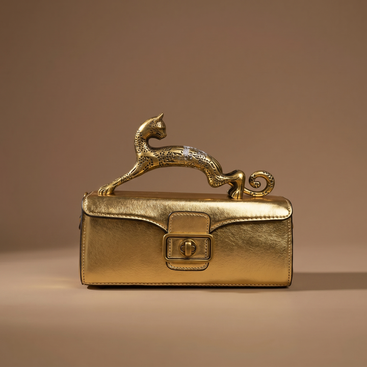 Sophisticated women's Portia luxury handbag. Sculptural leather design with bold leopard print and brass hardware.