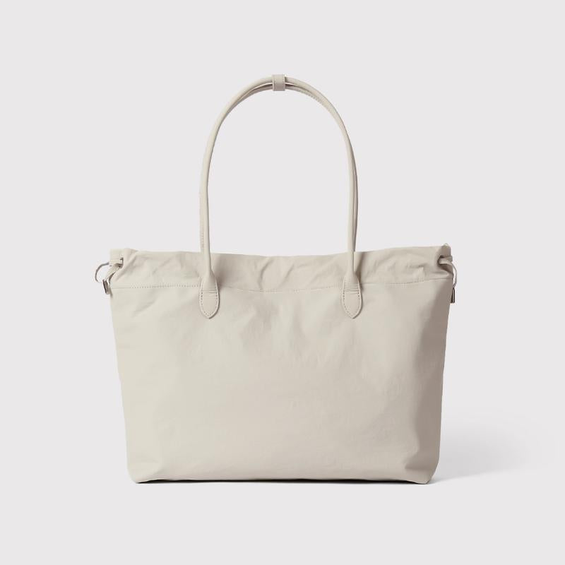Women's premium beige leather tote bag, spacious & elegant work carryall, minimalist style.