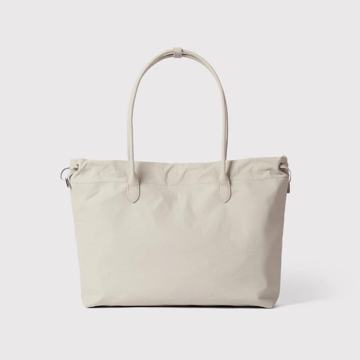 Women's premium beige leather tote bag, spacious & elegant work carryall, minimalist style.