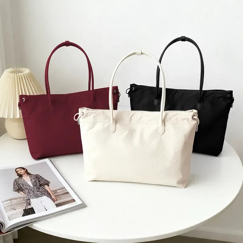 Close-up of premium quality leather texture & fine stitching on an elegant women's tote bag.