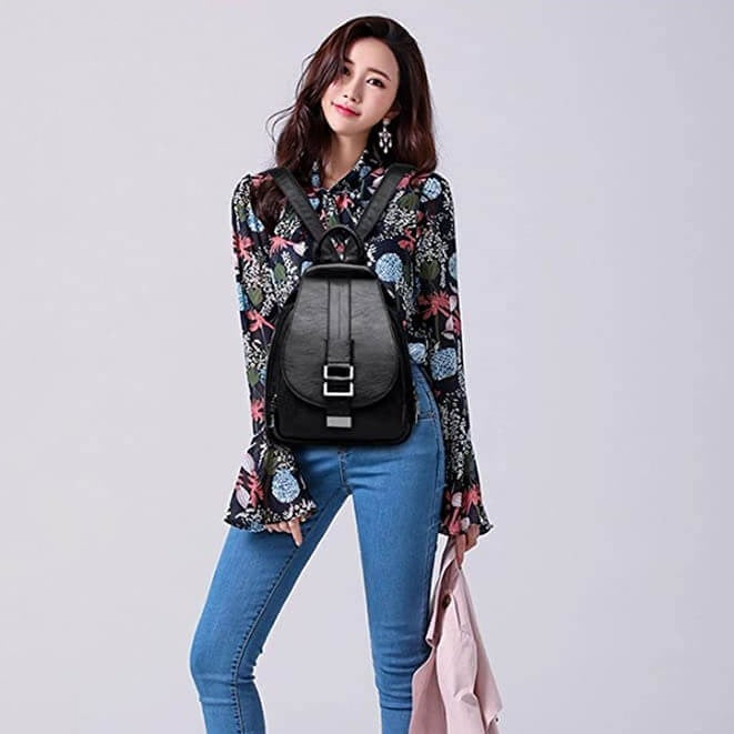 Designer women's water resistant leather backpack, luxurious and practical, worn by model.