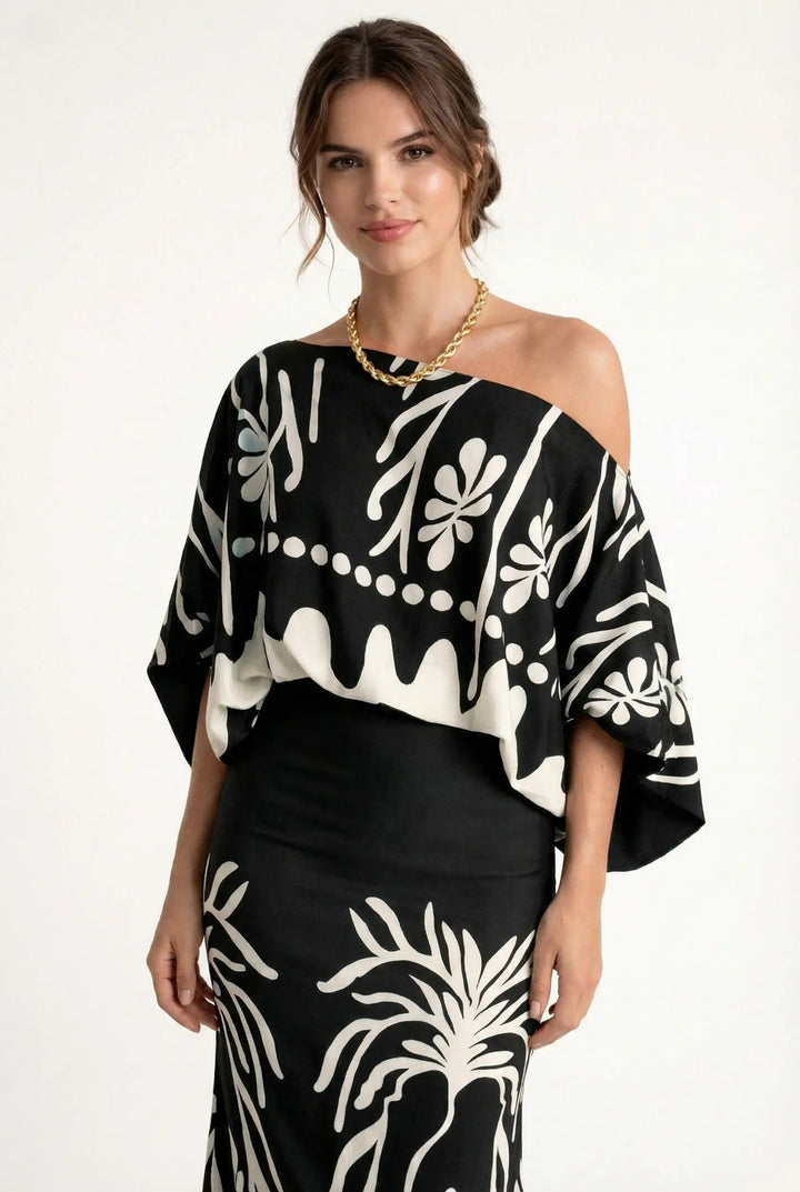 Fashionable women's summer outfit: a trendy printed blouse paired with a versatile maxi skirt for vacation.
