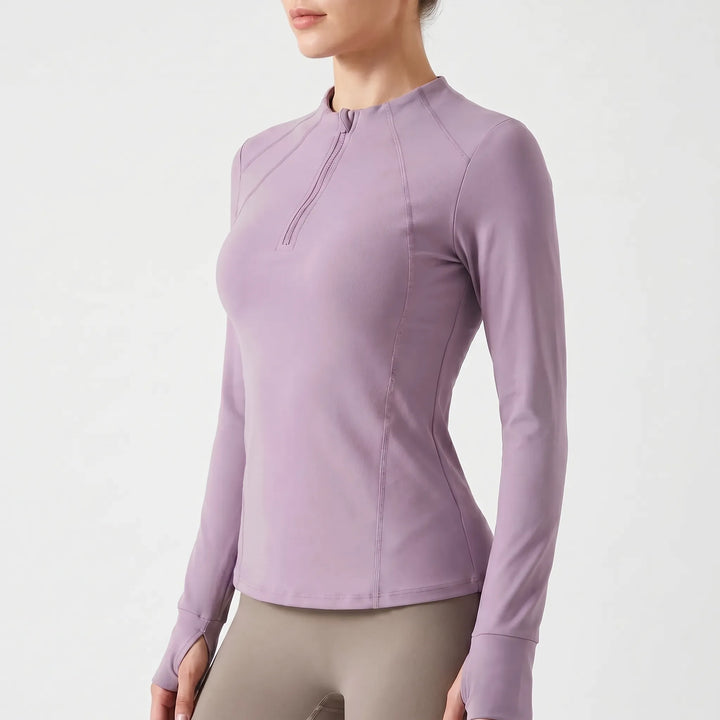 Breathable women's quarter-zip sports top, moisture-wicking, long sleeves with thumb holes for active fitness & layering.