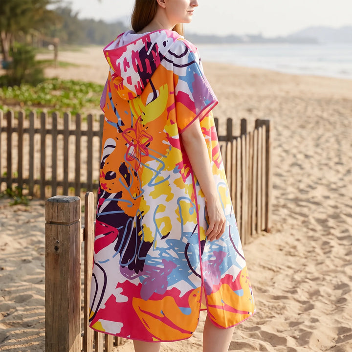 Stylish women's hooded changing poncho, vibrant abstract print, a quick-dry swimwear cover-up & pool accessory.