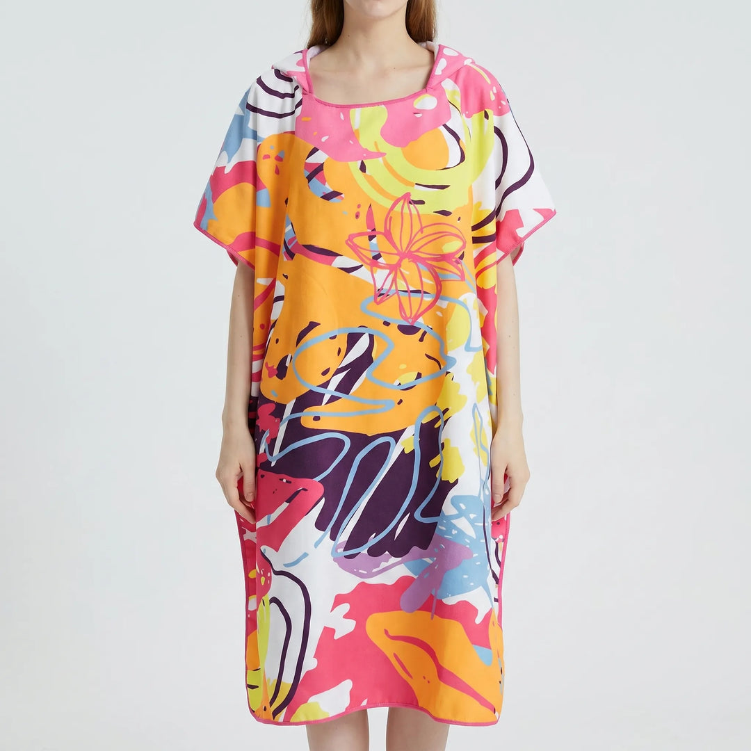 Women's hooded beach cover-up poncho with vibrant abstract print, quick-dry fabric, ideal changing robe & travel essential.