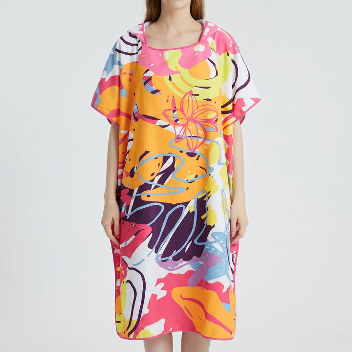 Women's hooded beach cover-up poncho with vibrant abstract print, quick-dry fabric, ideal changing robe & travel essential.