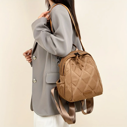 Versatile women's quilted nylon backpack easily converts to a stylish shoulder bag for daily use.