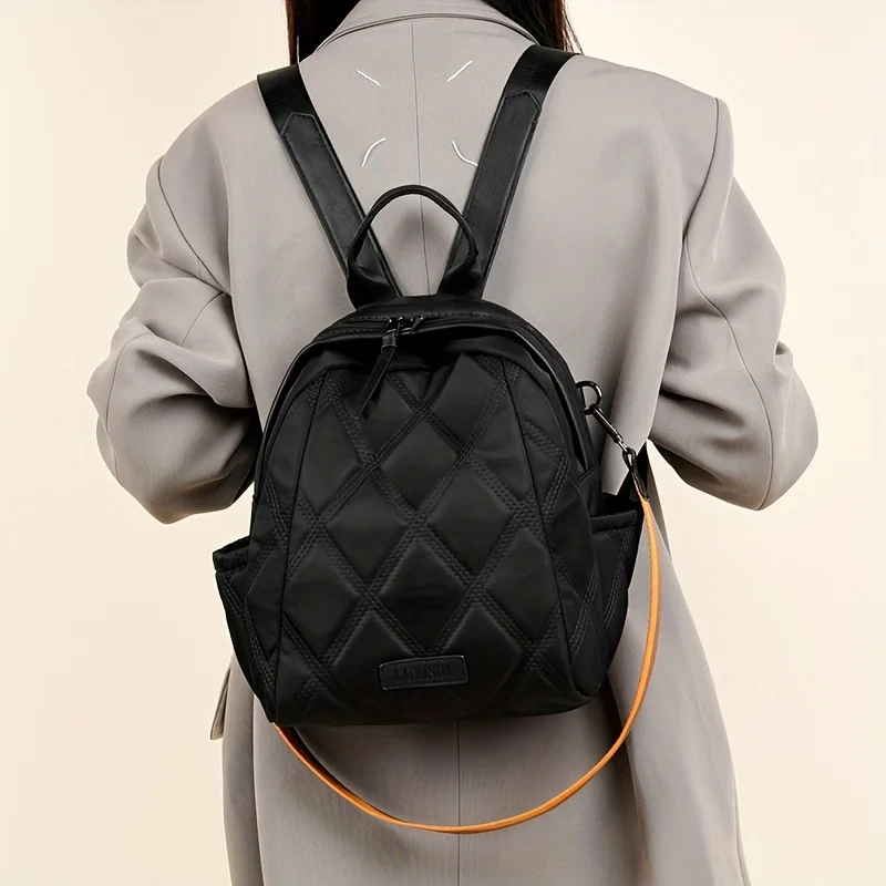 Durable women's quilted travel backpack, perfect for trips, easily converts to a shoulder bag.