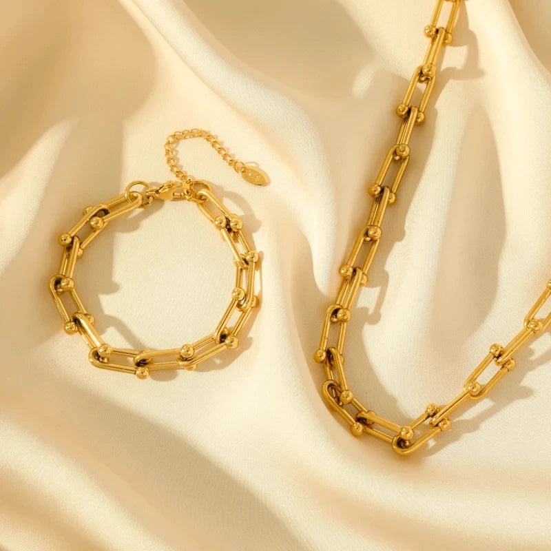 Detail of polished radiant gold link chain, elegant women's jewelry set component.