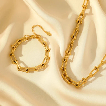 Detail of polished radiant gold link chain, elegant women's jewelry set component.