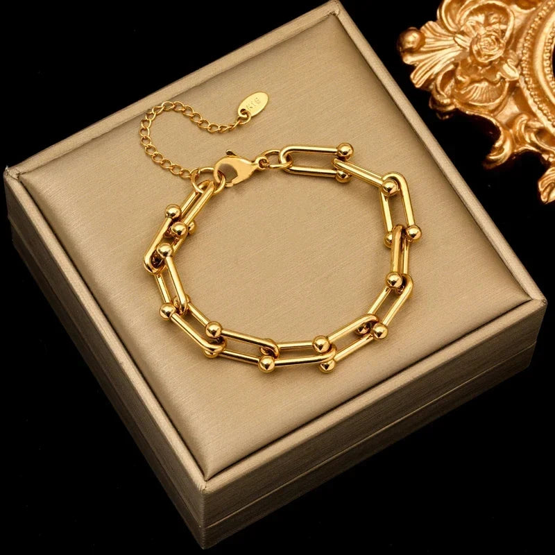 Stunning gold link chain necklace and bracelet jewelry set, radiant and polished finish.