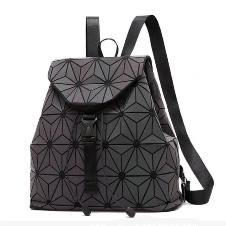 Woman wearing a vibrant reflective geometric luminous backpack, front view, stylish and modern.