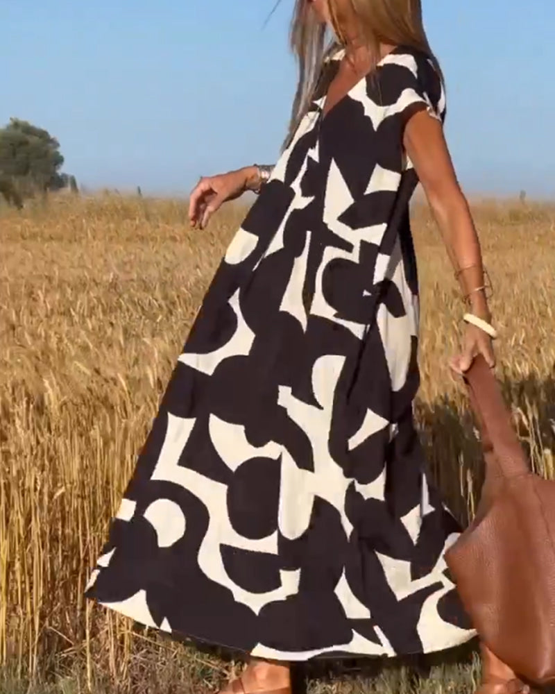 Relaxed fit women's abstract V-neck dress with cap sleeves, offering effortless comfort for everyday.