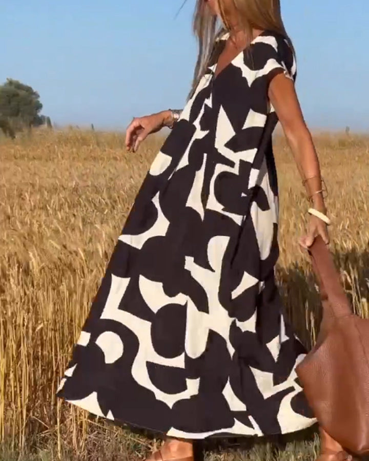 Relaxed fit women's abstract V-neck dress with cap sleeves, offering effortless comfort for everyday.